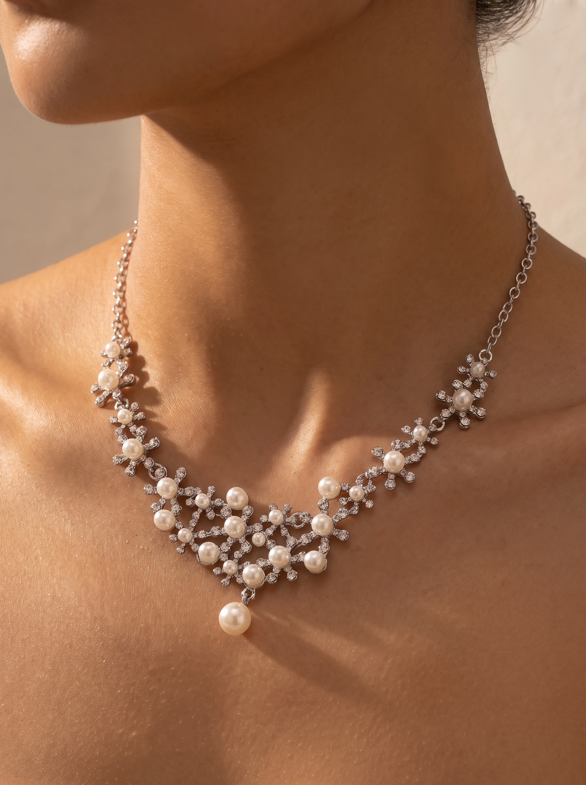 La Neve pearl and crystal necklace close-up on the collarbone — FYNX