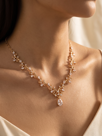 La Vite gold vine necklace close-up on the collarbone — FYNX