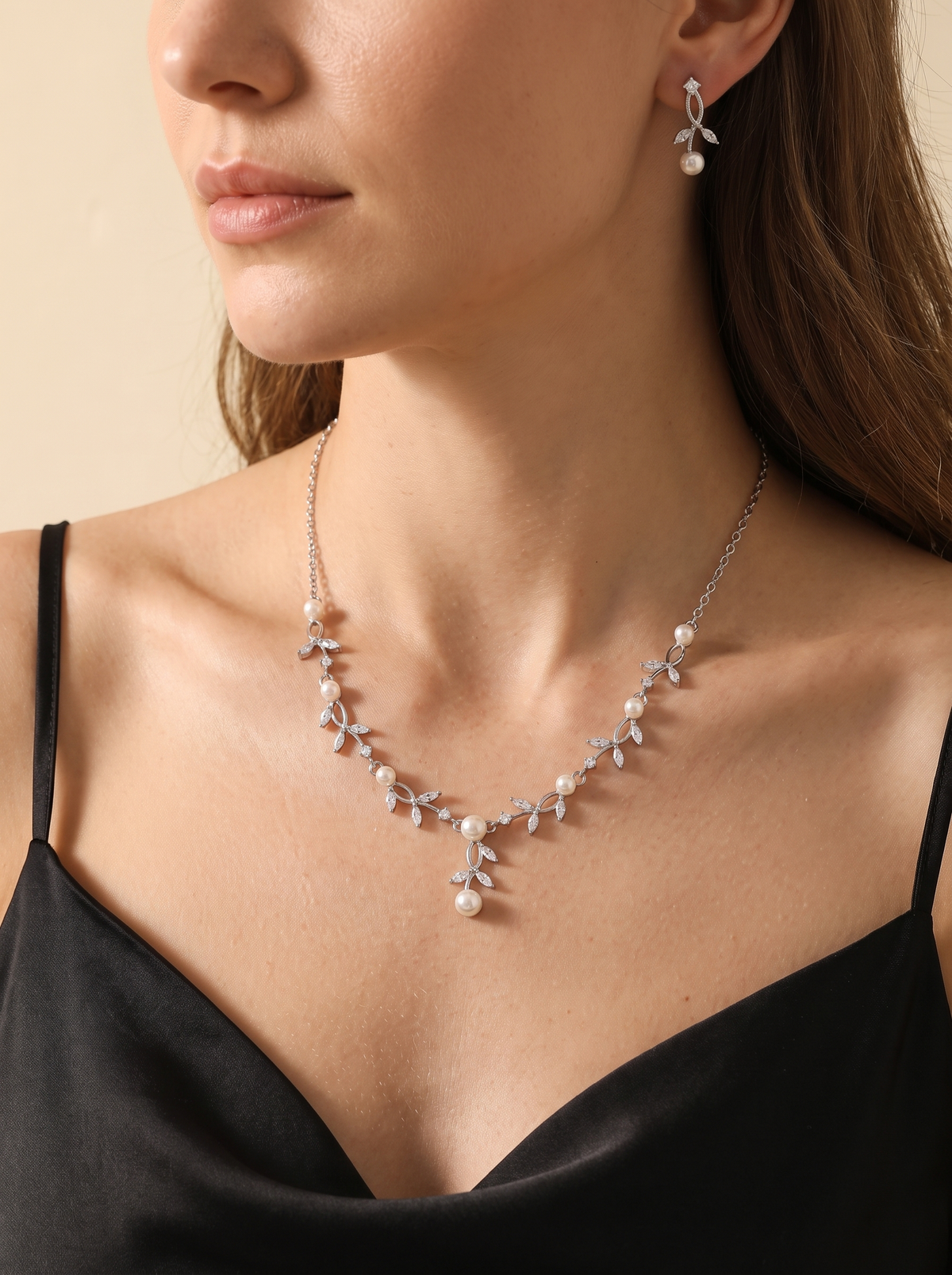 Il Sussurro pearl necklace and earring set worn by a model — FYNX